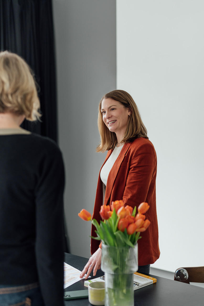 Beratungssituation einer Energieberaterin bei einem Brand Shoot. Christin spricht gerade mit einer anderen Person.