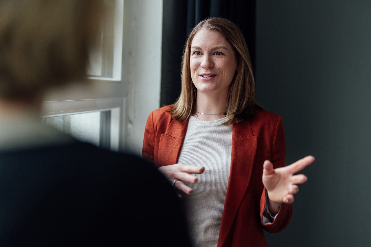 Beratungssituation einer Energieberaterin bei einem Brand Shoot. Christin spricht gerade mit einer anderen Person.